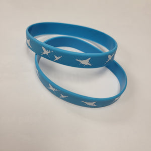 Two blue silicone bracelets with a white pattern, displayed on a white background.