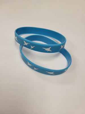 Two blue silicone bracelets with a white pattern, displayed on a white background.