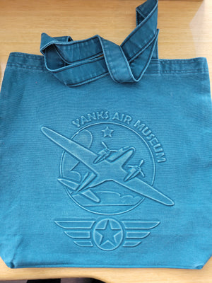 Yanks Air Museum and logo medium-sized tote bag with embossed airplane design, primarily in blue or green denim , with carrying straps.