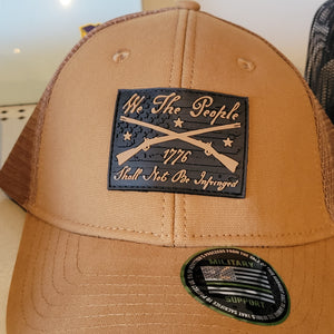Brown camel snapback hat with 'We the people shall NOT BE INFRINGED' text and a Howitzer logo on the front panel.