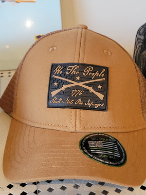 Brown camel snapback hat with 'We the people shall NOT BE INFRINGED' text and a Howitzer logo on the front panel.