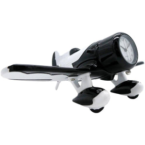 A desk clock designed to resemble a black and white Gee Bee racing airplane with wings and propellers.