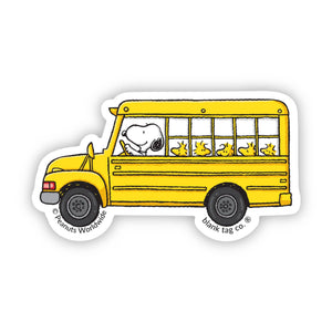 Sticker of a yellow school bus with Snoopy driving, featuring 'Peanuts Worldwide' 