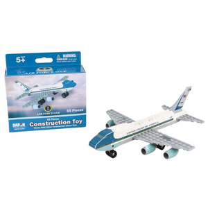 A toy construction set of an Air Force One airplane shown next to its retail box. The assembled model features a white fuselage with a blue and gold stripe, gray wings, and light blue engines, while the packaging displays the product details and branding.
