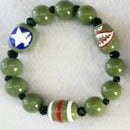 Beaded shark mouth bracelet with green beads and colorful accents on a white background