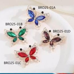 Butterfly-shaped jewelry with clear gemstones on a white background