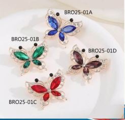 Butterfly-shaped jewelry with clear gemstones on a white background