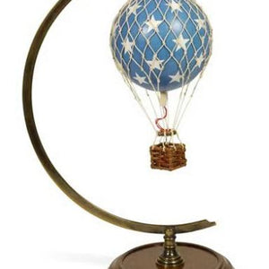 Decorative hot air balloon model on a stand with a white background