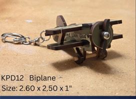 Metal keychain with die cut wood air[plane  on a brown background