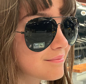 Black aviator sunglasses with 'Deluxe Edition' label.