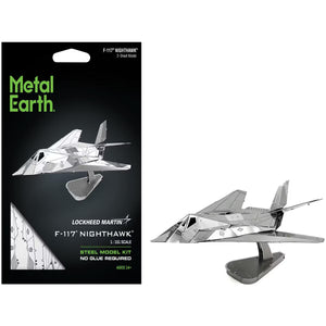 Metal Earth F-117 Nighthawk steel model kit packaging shown next to the assembled silver metal model on a display stand against a white background.