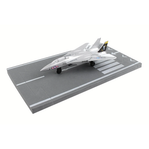 A silver model F-22 Raptor fighter jet displayed on a gray miniature aircraft carrier deck, photographed against a solid white background.