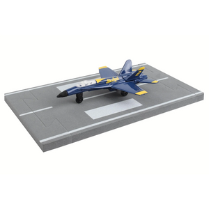 Model airplane on a miniature runway with a white background
