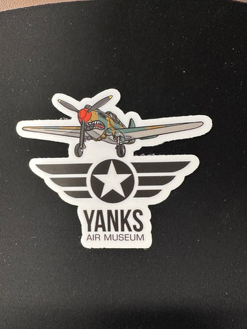 Sticker of a vintage P-40 Warhawk airplane with a star and 'Yanks Air Museum' logo black background