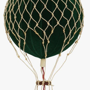 Green hot air balloon with a wicker basket on a white background