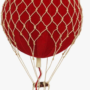 Red hot air balloon with a wicker basket on a white background