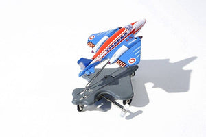 A toy airplane with a spring mechanism, predominantly blue with red and white accents, mounted on a chassis, displayed against a white background.