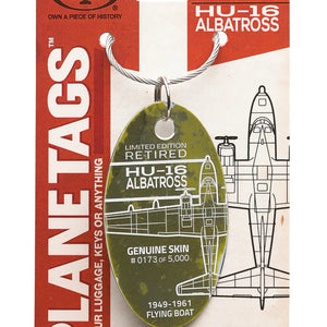 A collectible Moto Art airplane tag with a Grumman HU-18 Albatross design, featuring text and illustrations related to the history of the aircraft.