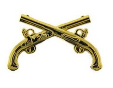 Two gold-colored metal pins shaped like pistols, crossed over each other.
