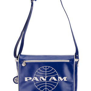 A blue messenger bag with an embossed Pan Am logo and a brushed nickel hardware detail.