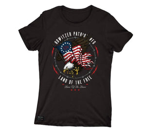 A black short-sleeve crewneck t-shirt featuring a circular graphic on the chest with an eagle, American flag, and the text 'HOWitzer PATRIOT AGE LAND OF THE FREE'.