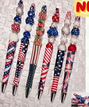 Decorative pens with American flag design on a textured surface