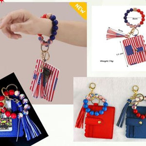 Keychain with American flag design and tassel, displayed on a hand and with additional keychains shown.