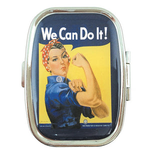 A metal pill box with a reflective top surface featuring an illustration of Rosie the Riveter, a woman with a red bandana and a fist, along with the text 'We Can Do It!'.