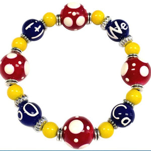 Colorful beaded we can do it bracelet with red, yellow, and blue beads on a white background