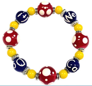 Colorful beaded we can do it bracelet with red, yellow, and blue beads on a white background