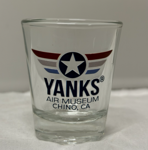 Clear glass shot glass with 'Yanks Air Museum Chino, CA' logo on a white surface.