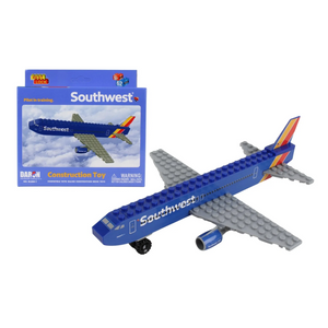 A blue Southwest airplane construction toy with gray wings and a red, yellow, and blue tail, shown next to its blue retail box on a white background.