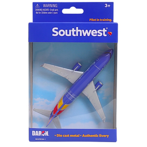 Southwest die-cast metal toy airplane in its original retail packaging by Daron. The blue and white airplane features the classic red and yellow Southwest livery on the tail, set against a blue sky background inside a clear plastic blister pack with a blue cardboard header.