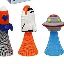 Three colorful toy figures resembling a rocket, astronaut, and UFO on a white background.