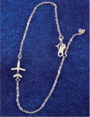 Silver airplane pendant on a chain against a blue background