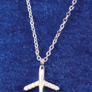 Silver airplane pendant necklace on a blue textured background