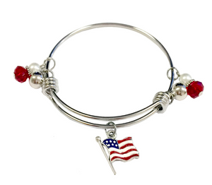 Silver bracelet with American flag charm and red and white beads on a white background