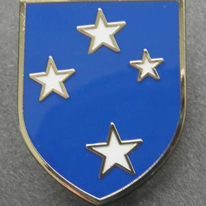 Pin with four silver stars on a blue background