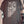 A black youth-sized t-shirt displayed on a hanger, featuring a flag design with white stars and the text 'We The People' on the front.