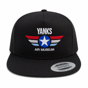 A black snapback trucker hat featuring an embroidered front patch with the text 'YANKS AIR MUSEUM' and a red, white, and blue winged star design. The hat has black mesh side panels and a silver 'Authentic Snapback' sticker on the brim, shown against a plain white background.