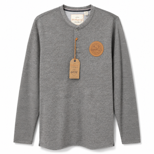 A gray long-sleeve henley shirt with a brown leather patch and matching hangtag on the chest, displayed against a clean white background.