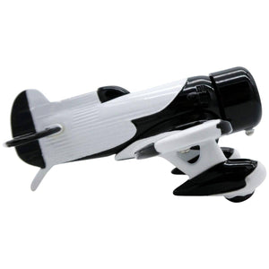 A desk clock designed to resemble a black and white Gee Bee racing airplane with wings and propellers.