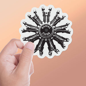 A round sticker with a black and white image of an airplane engine and the text 'Radial Flyer'.