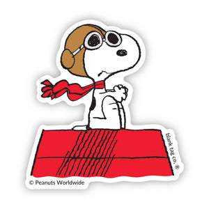 Sticker of Snoopy dog with glasses and a red scarf on a white background, featuring the 'Peanuts Worldwide' logo.