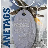 An F/A-18 Hornet Moto Art plane tag made from authentic skin, packaged on a card with logo and information about the product.