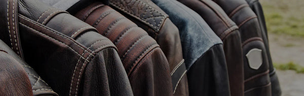 Row of leather jackets in various shades of brown and blue.