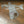 A clear glass paperweight in the shape of a vintage airplane, with visible details and a small American flag emblem.