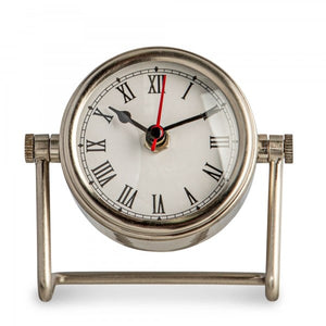 A vintage desk clock with a white face, black hands and Roman numerals, mounted on a silver-colored base.