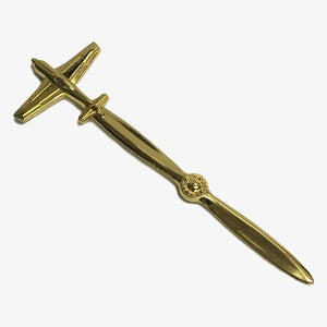 A gold-plated, sculptured airplane-shaped letter opener.