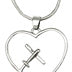 A silver necklace with a rope chain featuring a heart-shaped design with an airplane inside.